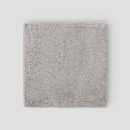 Gray textured fabric square Imabari towel on a light gray background