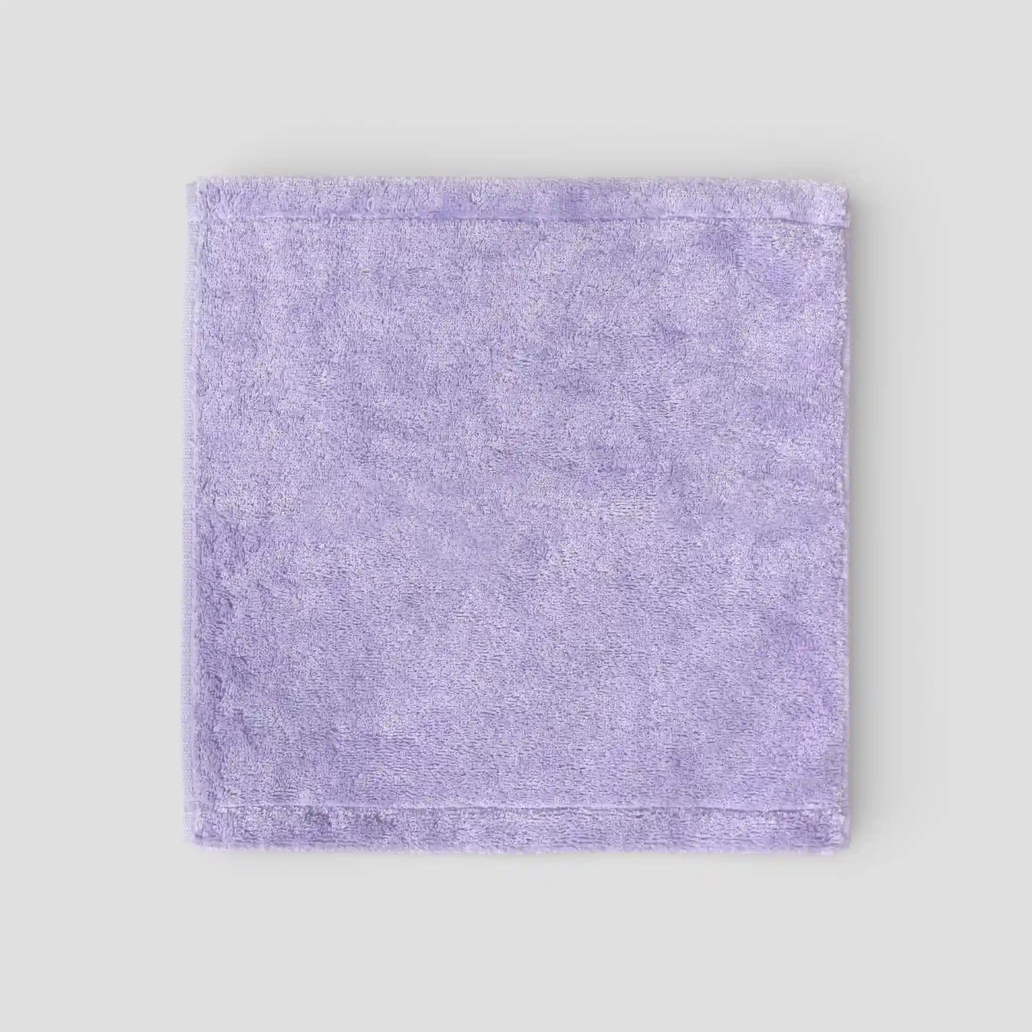 Purple Imabari towel on a light gray background