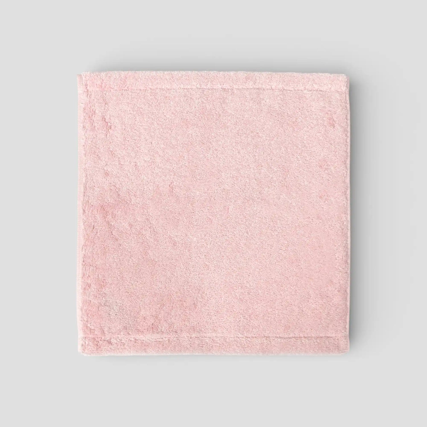 Pink Imabari towel on a gray background