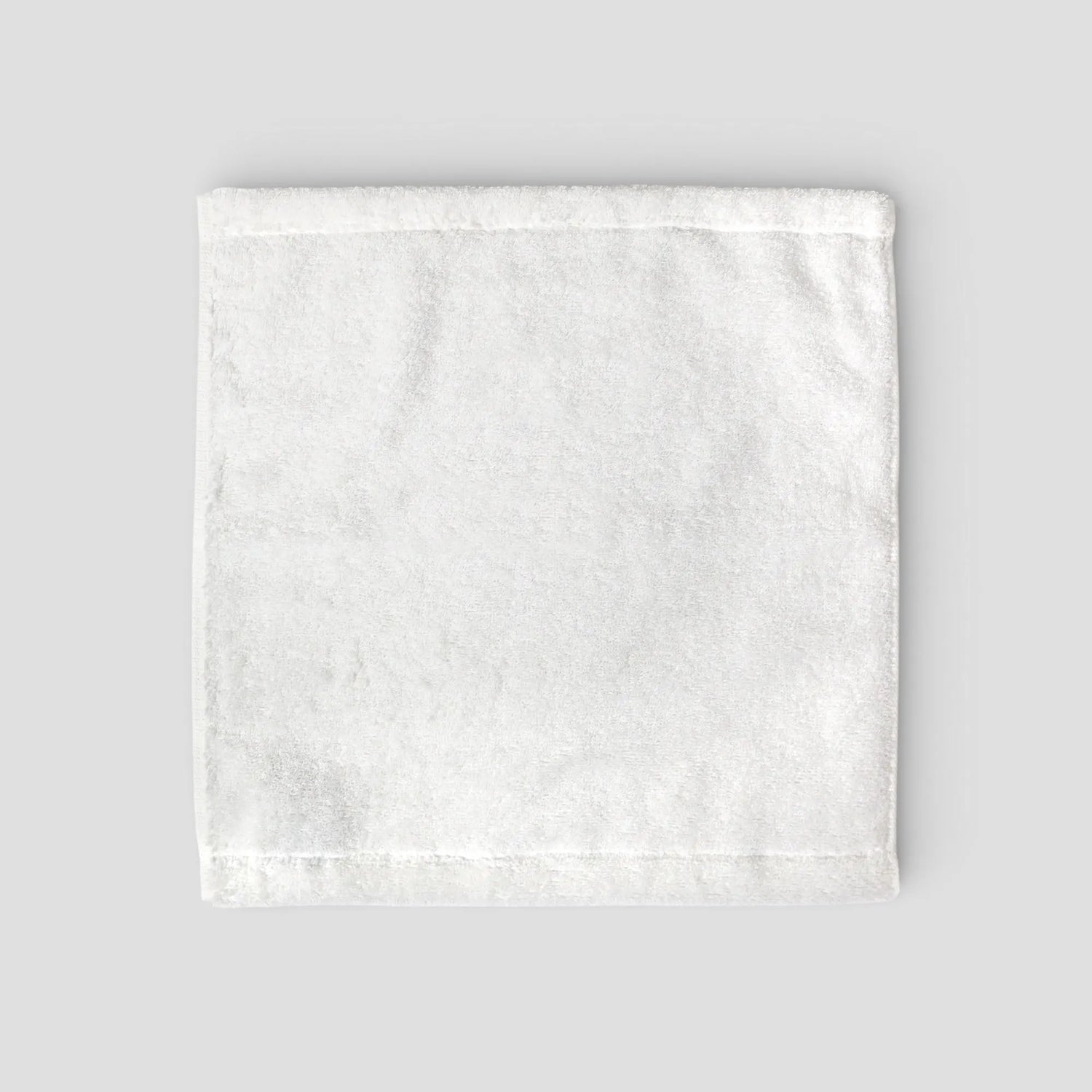 White textured Imabari towel on a light gray background