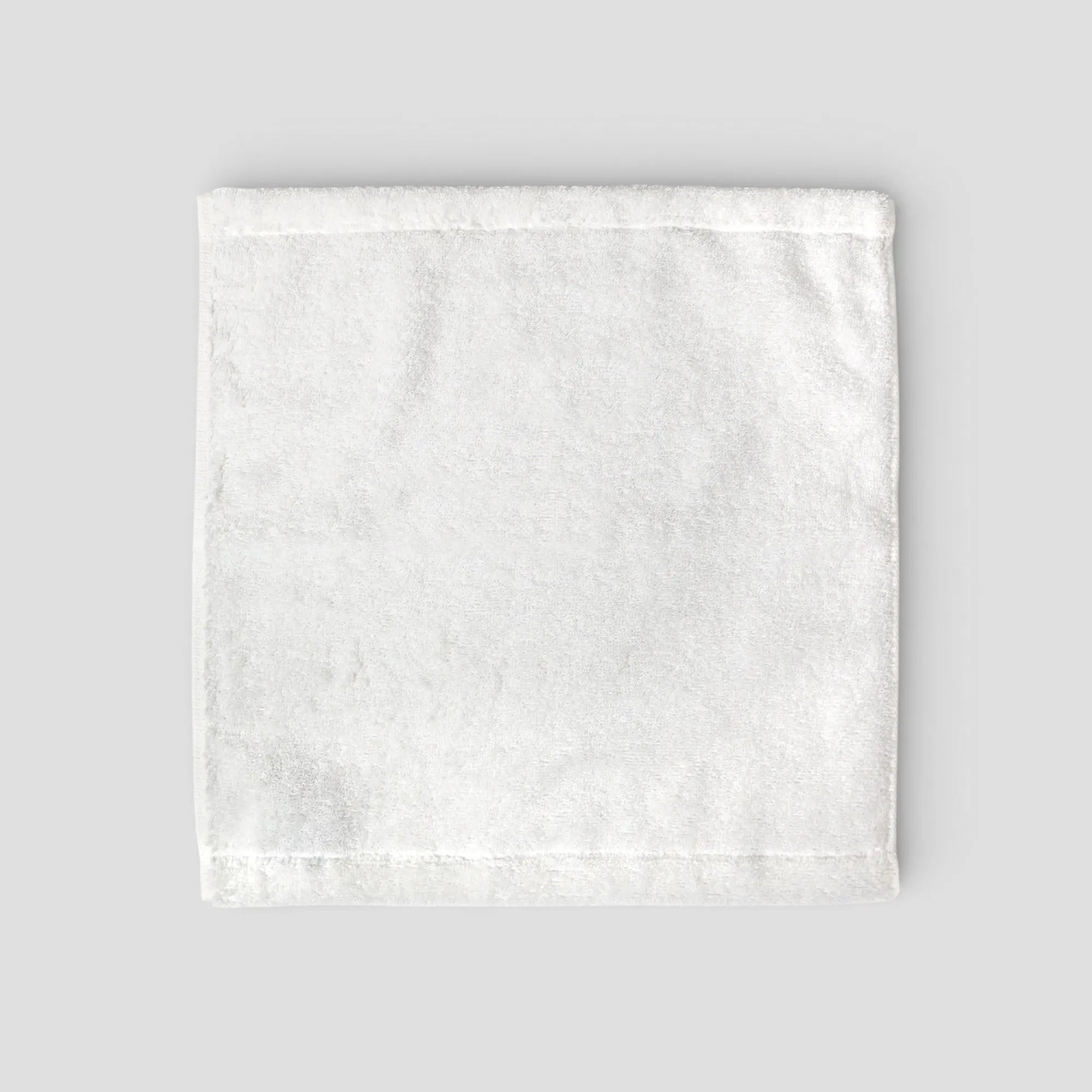White textured Imabari towel on a light gray background