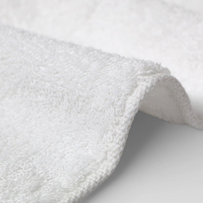Close-up of a white Imabari towel textured fabric on a light gray background