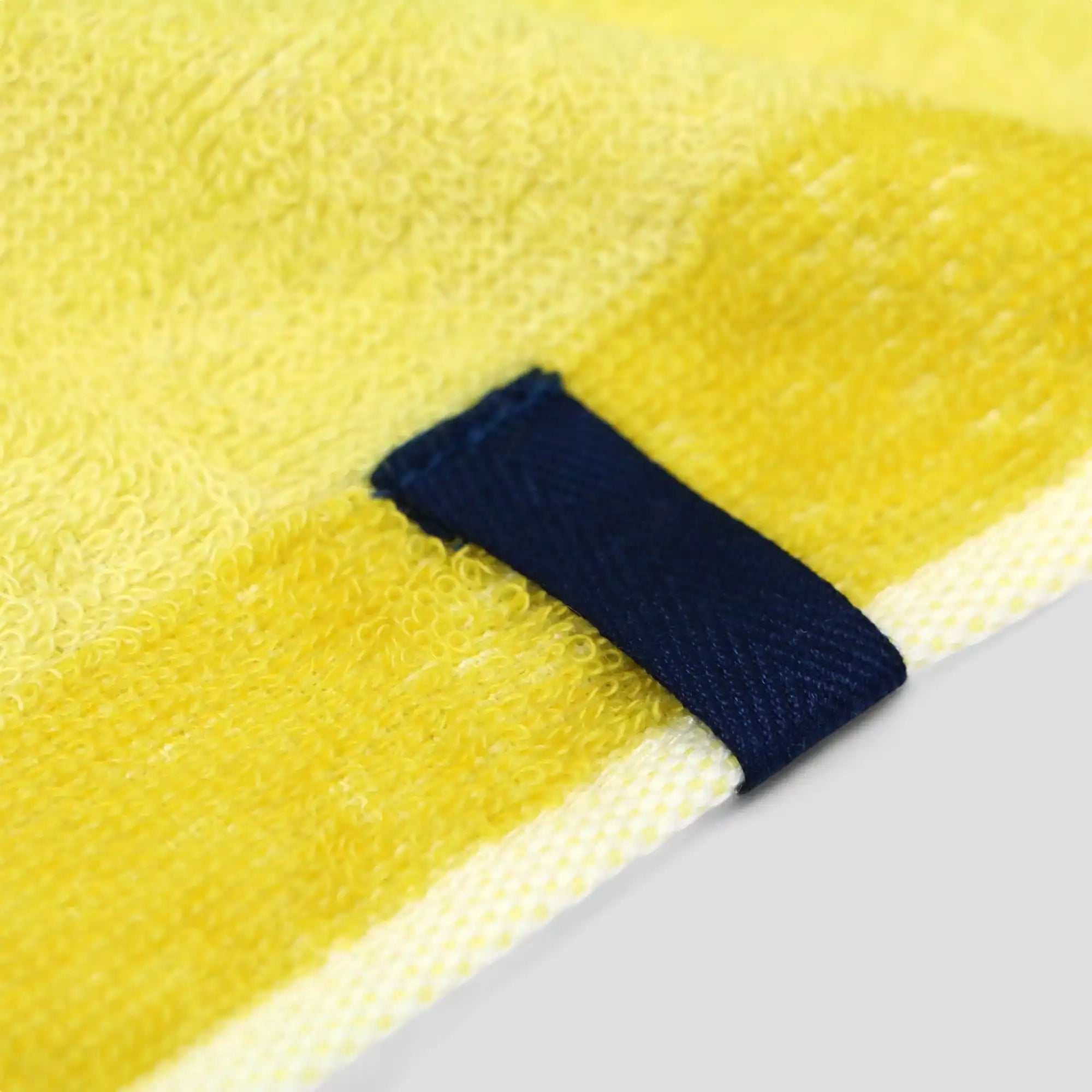 Close-up of the hanging loop on an yellow Imabari towel