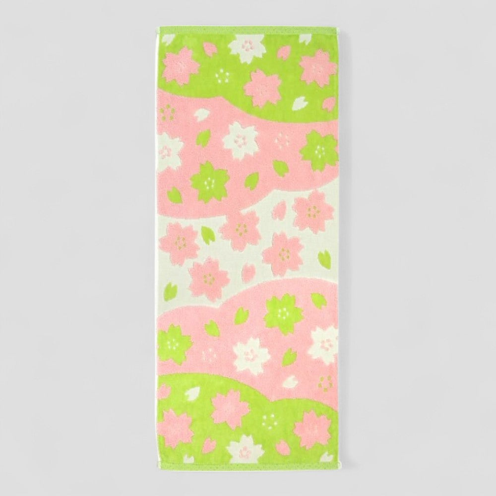 Floral patterned Imabari towel with pink and green flowers on a white background