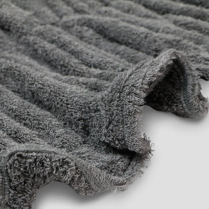 Close-up of gray textured Imabari towel fabric on a light background