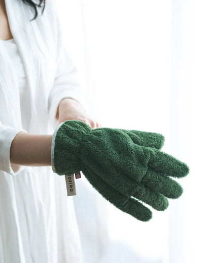 Green Imabari towel gloves held by a person against a white background