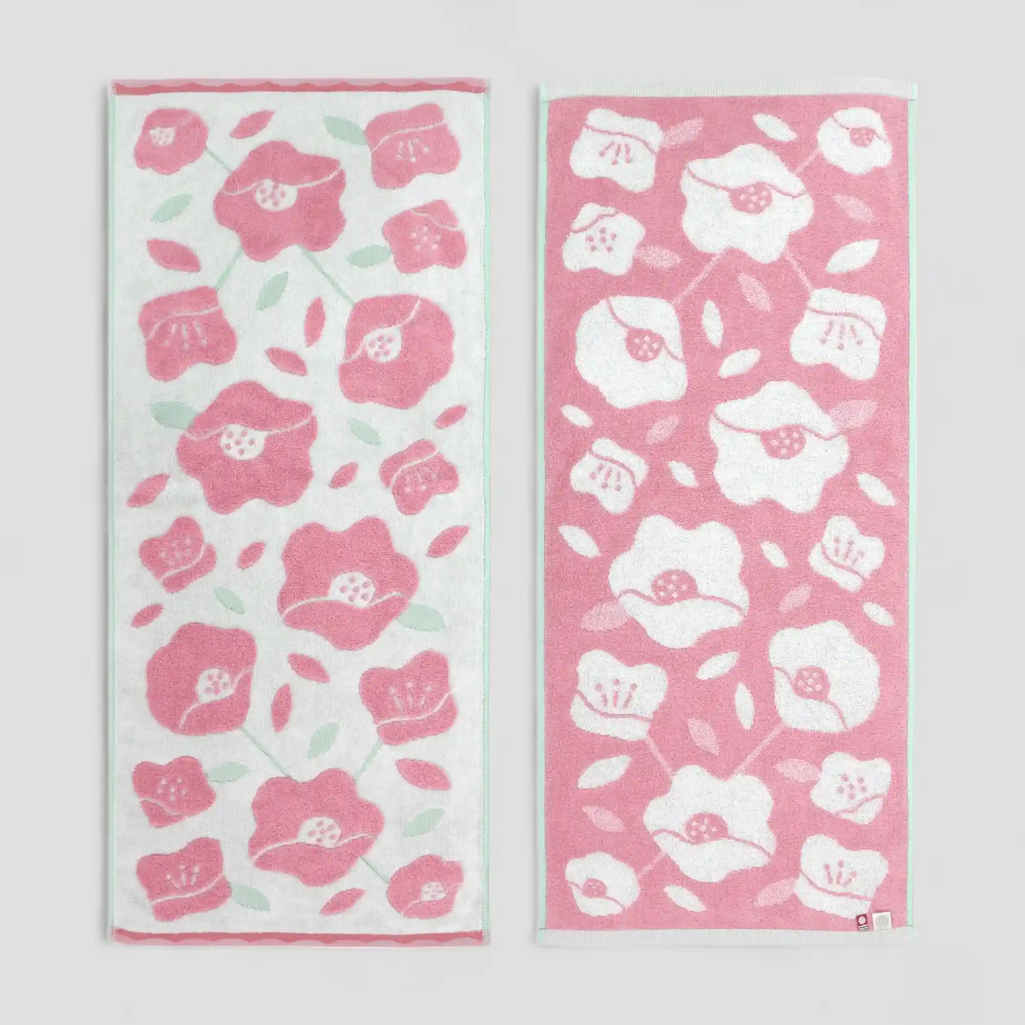 Two floral patterned Imabari towels on a light-gray background