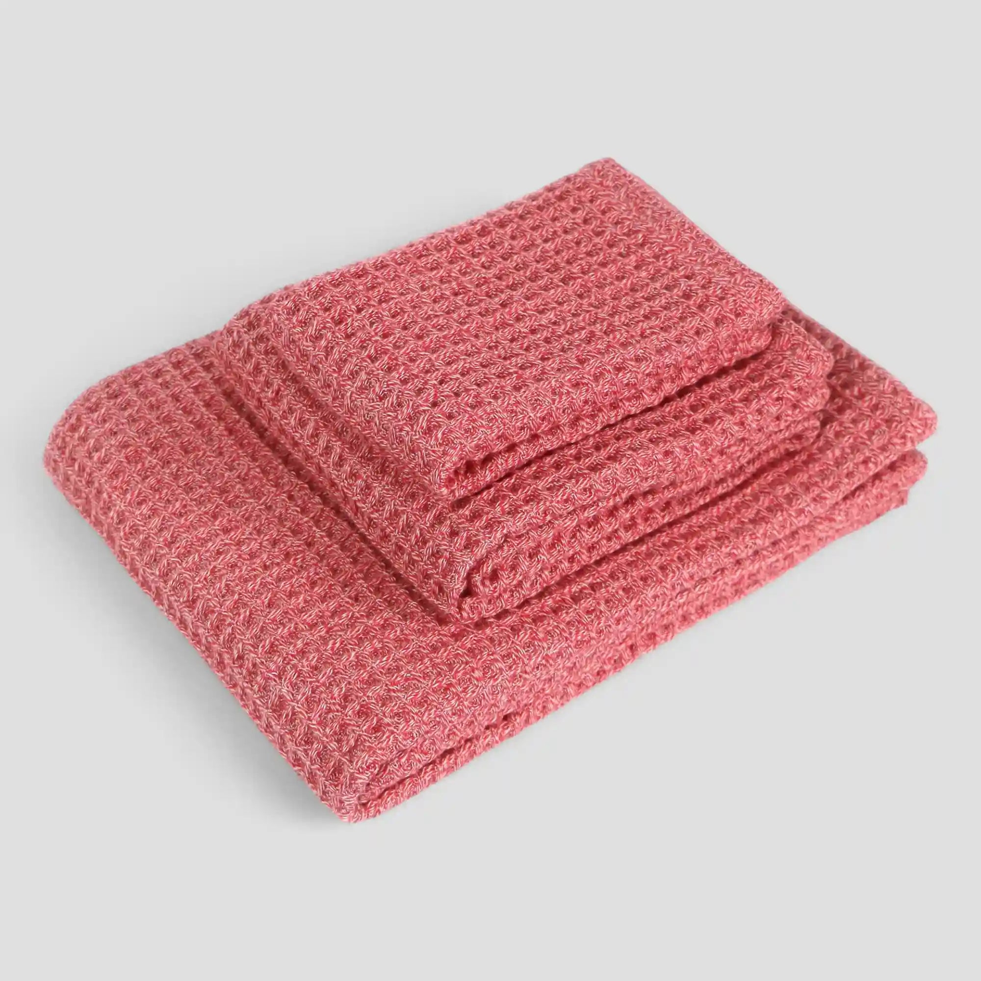 Folded 3 sets of red waffle towel on a light gray background