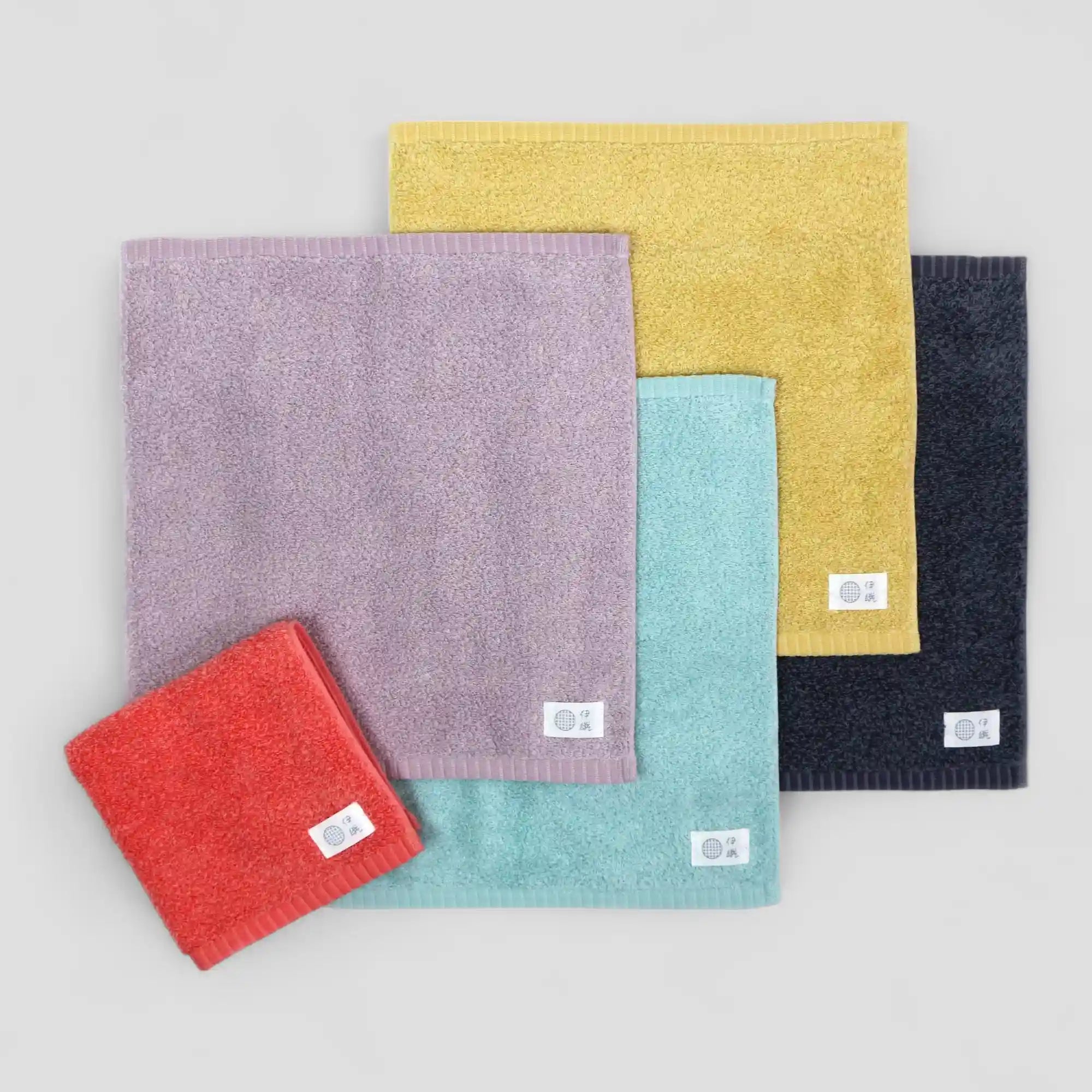 Set of colorful textured Imabari towels on a light gray background