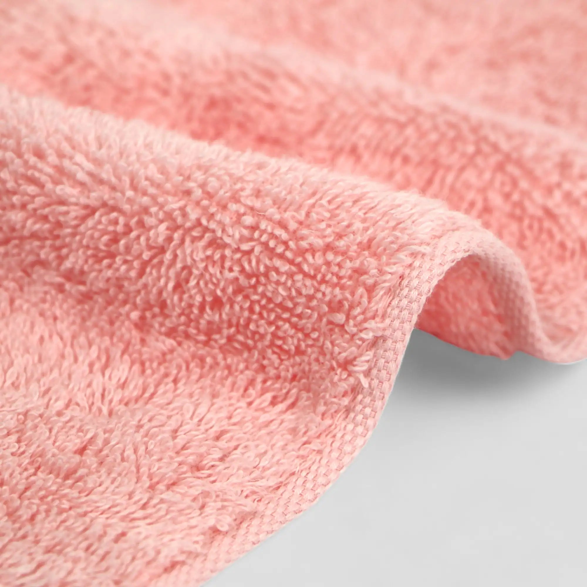 Close-up of a pink Imabari towel with a soft texture on a light gray background