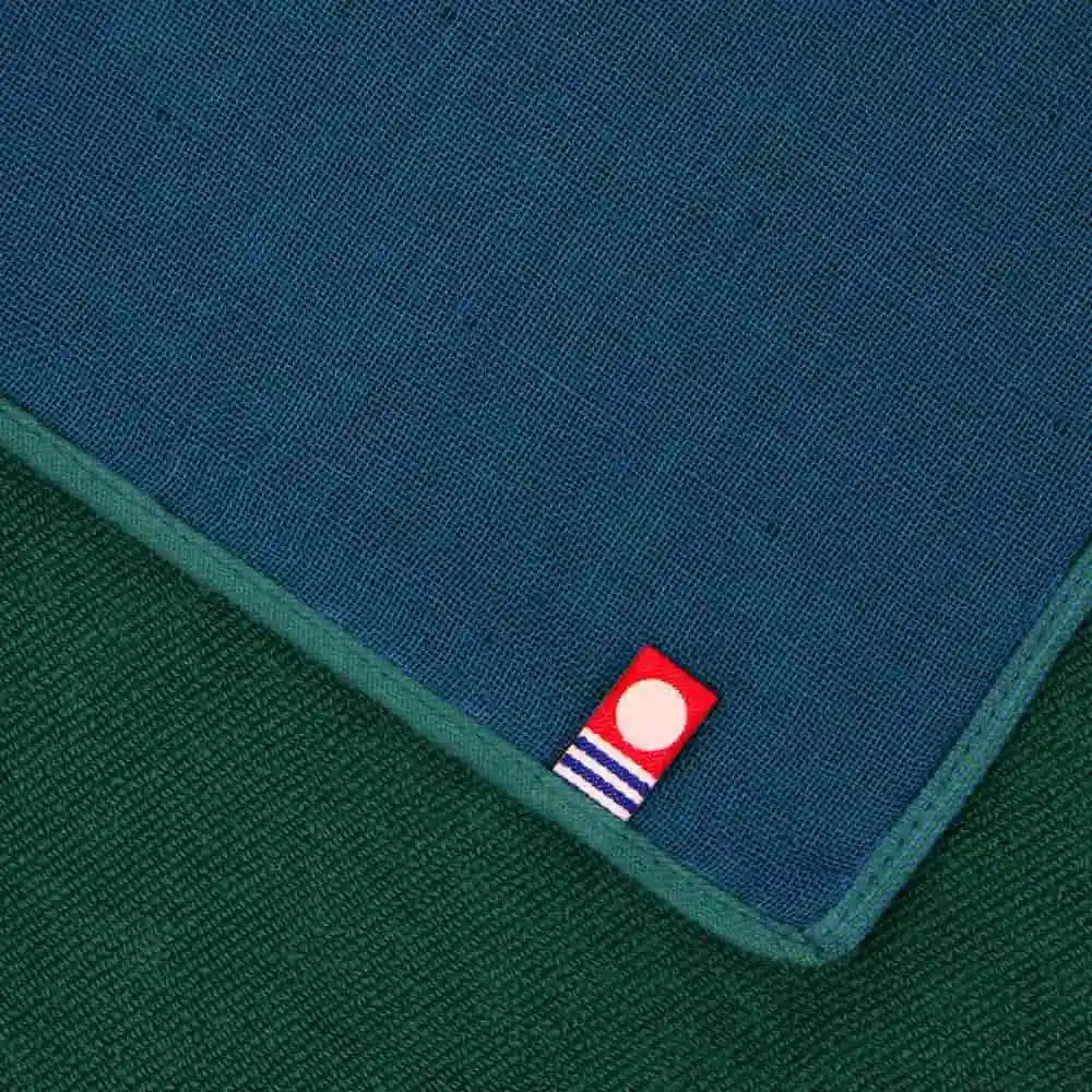 Close up of blue  and green Imabari towel with a babel of Imabari towel brand mark