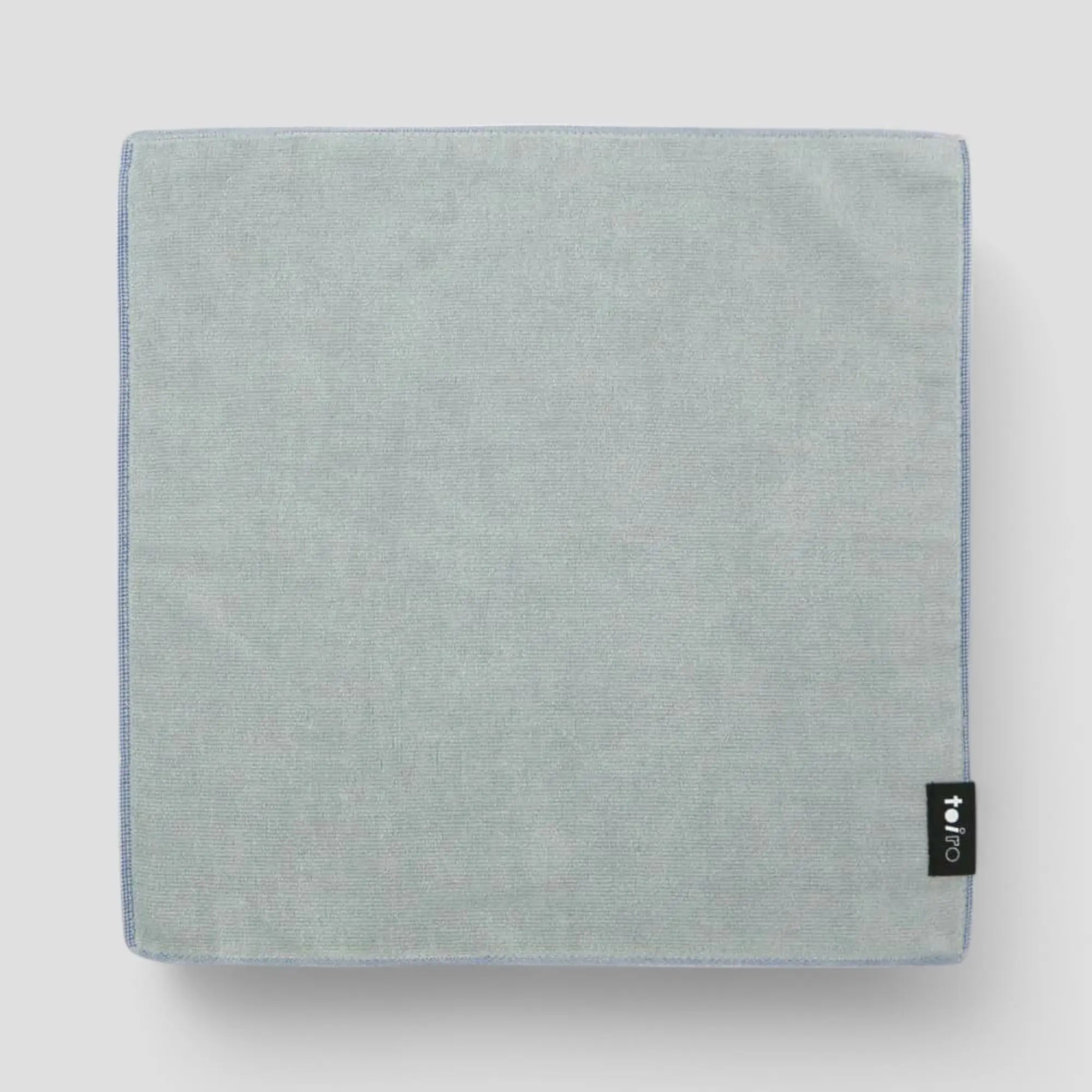 A square gray Imabari towel displayed light-gray background