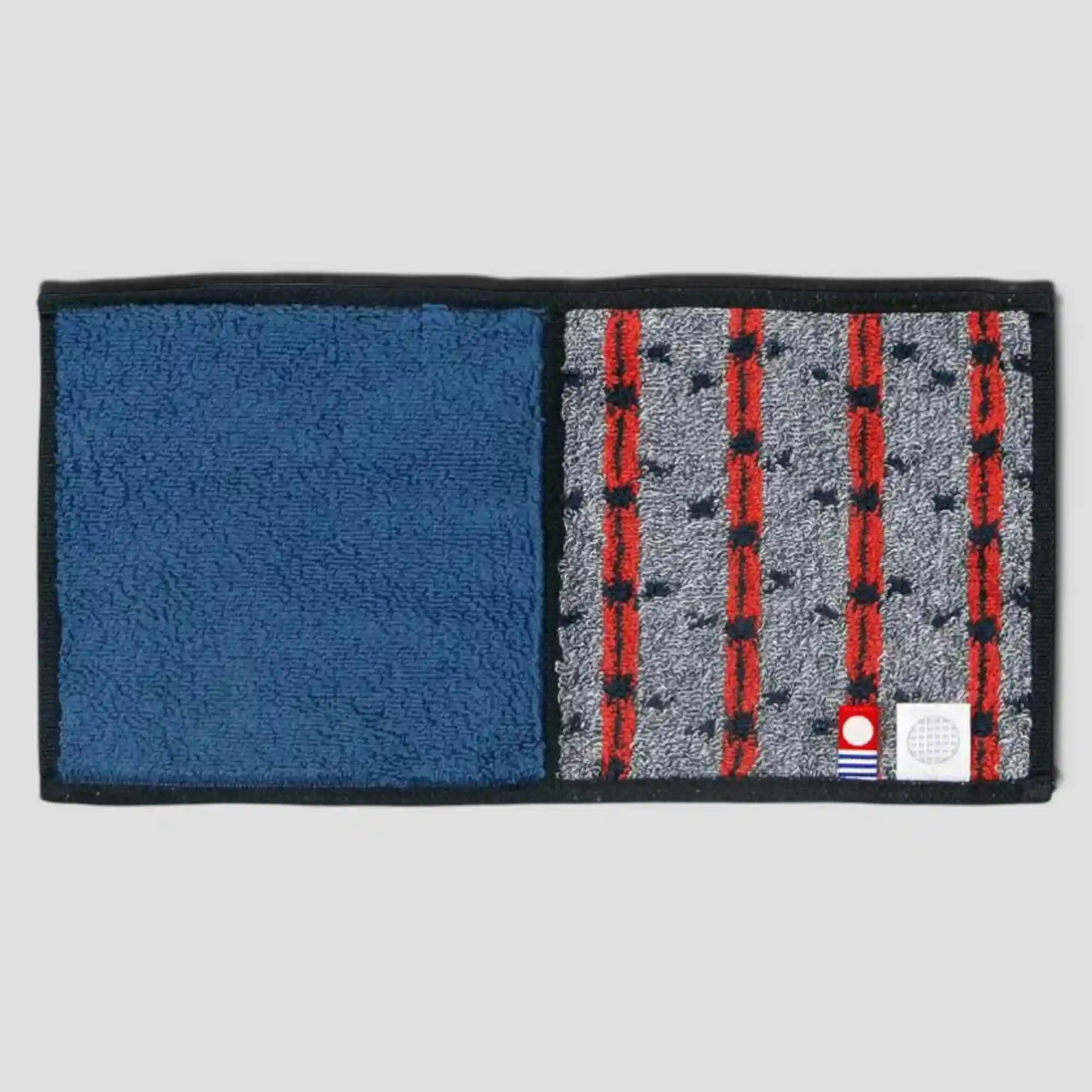 A Imabari towel in blue with red pattern, back side, displayed against a white background.