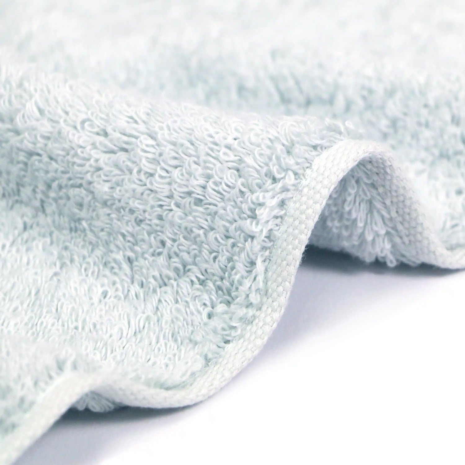 Side shot of the soft texture of the Iori Lotus premium Imabari bath towel in blue.