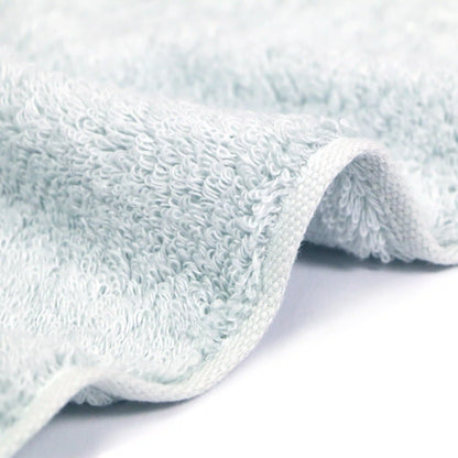 Side shot of the soft texture of the Iori Lotus premium Imabari bath towel in blue.