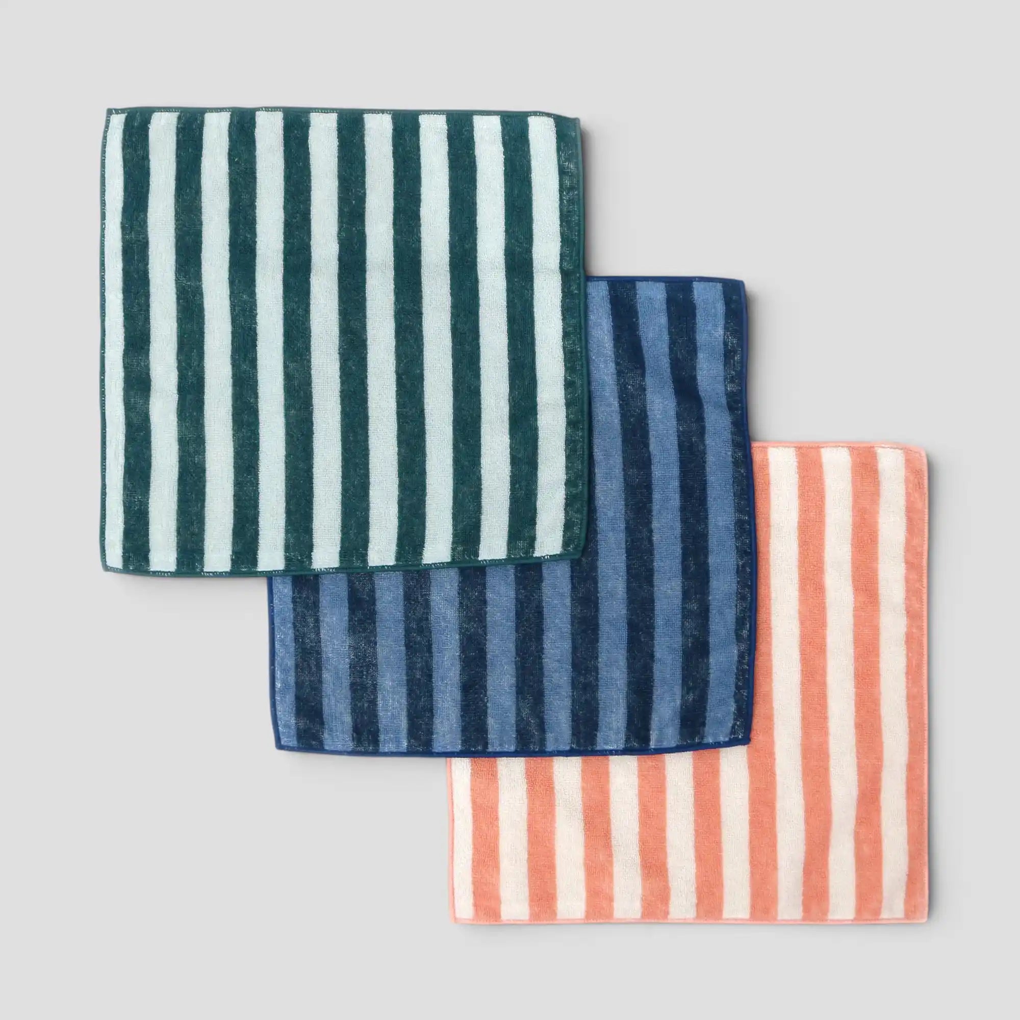 Three striped Imabari towels in green, blue, and pink on a light gray background