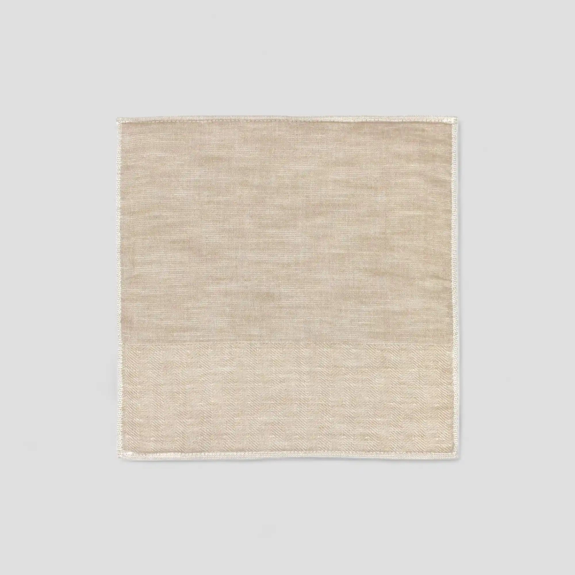 Beige Imabari towel with a subtle herringbone pattern on a light gray background.