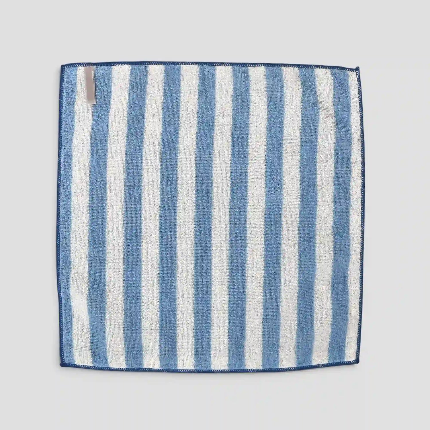 Blue and white striped Imabari towel fabric square on a light gray background