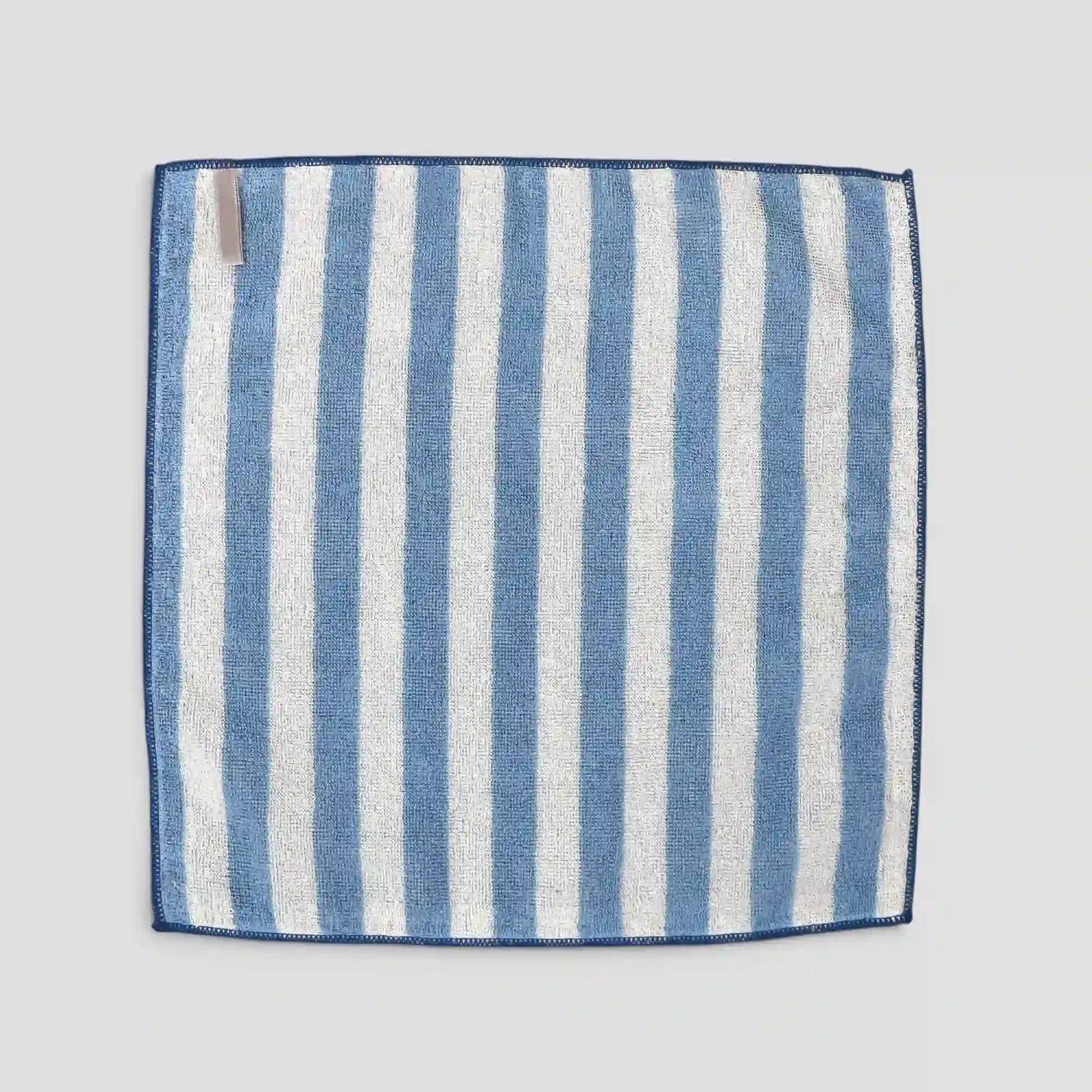 Blue and white striped Imabari towel fabric square on a light gray background